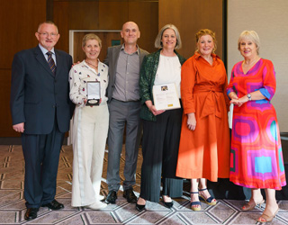 Judging panel standing by the submitted works