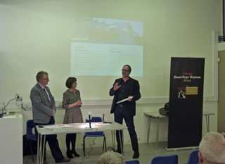 Judging panel standing by the submitted works